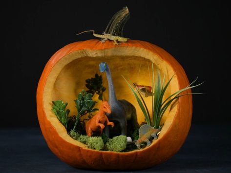 Turn your typical jack into a delightful dino diorama. Kids can totally decorate this prehistoric pumpkin with items found in their toy box. Pumpkin Dinosaur Ideas, Dinosaur Pumpkin Decorating Ideas, Dino Pumpkin Carving Ideas, Dinosaur Pumpkin Carving, Dino Diorama, Creative Pumpkin Decorating Contest, Dino Pumpkin, Pumpkin Dinosaur, Dinosaur Pumpkin