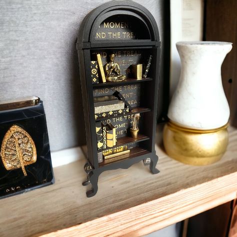 This miniature bookshelf makes the perfect desk decor for book lovers, a unique gift for your favorite book nerd, coworker gift or just a cute addition to your home bookshelf! Choose your top color. Each bookshelf comes with several books and a plant, moss, or other small feature (also available is beer cans, liquor bottles, perfume bottles, camera, or customize!) Note, each book is hand made and therefore colors and placement may vary product to product. However, leave a note if you have specific colors you'd like! Find more miniature bookshelves in my shop! Thank you for shopping with me! Please feel free to reach out if you have any questions. Want $5 off your order of $25 or more? Sign up for our newsletter here! http://eepurl.com/iqcdCQ Victorian Bookshelf, Bookshelf Unique, Styled Bookshelves, Style Bookshelf, Miniature Bookshelf, Library School, Home Bookshelves, Victorian Books, Perfect Desk