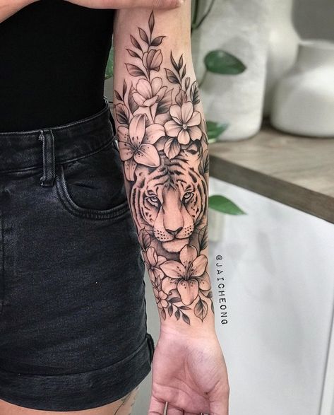 Full Sleeve Tattoos Women Tiger, Tiger Flower Sleeve Tattoo, What Does A Tiger Tattoo Represent, Tiger And Flower Tattoo Half Sleeves, Half Sleeve Tattoos For Women Upper Arm Tiger, Tiger Tattoo Flowers, Tiger And Flower Tattoo For Women, Flowers On Forearm Tattoo, Pretty Animal Tattoos