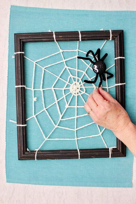 "This DIY Spider Web Craft with Yarn turns a simple frame into a spooky web for Halloween! It's an easy craft for kids to weave into a fun Halloween decoration for a party.  Are you ready for a fun Halloween craft for kids? This woven web is simple to make with just a few craft items!  I take our dog for a walk in the mornings when it’s cool and there is dew on the grass. The dew makes it possible to see spider webs on the trees and bushes, they just sparkle in the sunlight!  Spider webs have Craft With Yarn, Diy Spider Web, Edible Kids Crafts, Snowy Owl Craft, Spider Web Craft, Diy Spider, Kids Fathers Day Crafts, Easy Craft For Kids, Fun Halloween Crafts