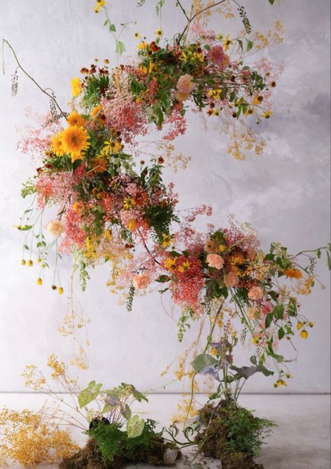 Floating curved arch of flowers. light yellows, deep golds, bold pinks, light peaches, airey garden style. Hanging Flower Arrangements, Summer Florals, Flying Flowers, Spring Window, Spring Wildflowers, Flower Installation, Wire Flowers, Floating Flowers, Floral Branch