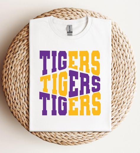 This T-Shirt is perfect for tailgating, game days or any casual occasion. It's a must-have for LSU fans and would make an excellent gift for family and friends. Geaux Tigers!    ➡️This is a DTF print (Direct to Film) heat pressed onto garment. ➡️T-shirt Brands: Gildan Soft Style, Hanes or Jerzee at this time.  ➡️Unisex Sizing - True to size, but for a trendy, oversized look, we recommend sizing up.  Please note: Colors in listings might vary slightly based on your device and print size may diffe Pep Squad, Lsu Fans, Go Tigers, Lsu Football, Geaux Tigers, Cute Womens, Tiger Shirt, Dtf Print, Tiger T Shirt