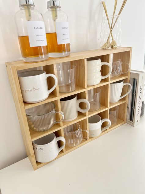 This wooden mug shelf unit is carefully crafted from high-quality materials, providing a sturdy and long-lasting storage solution for your favorite mugs. Made with precision and expert craftsmanship, this unit will add a touch of elegance and organization to your kitchen or dining area. With its charming design and durability, you won't have to worry about cluttered countertops or fragile mugs. Keep your mugs within reach and beautifully displayed with our Wooden Mug Shelf Unit. Dimensions: Widt Kitchen Shelf Decorations, Student Kitchen Decor, Mug Cabinet Organization, Shelf For Mugs, Cup Shelf Display, Mugs Organization, Cute Kitchen Decor Apartment, Kitchen Shelves For Mugs, Mug Shelf Display