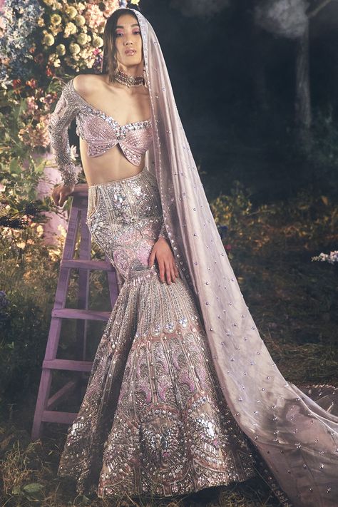 A 3-piece mermaid cut lehenga in lilac embroidered with silver metal embellishments, precious crystals, and 3D floral glass cut beads. This lehenga is completed with a waist side cut covered with tulle and silver embroidered tassels. It is paired with a signature Papa Don't Preach butterfly full-sleeved blouse appliqued in lilac silks. This look is completed with a tissue organza embroidered dupatta in lilac. #perniaspopupshop #whatiworewastrending #ppuslove #papadontpreach #rakhi #teej Papa Don't Preach, Purple Lehenga, Metal Embellishments, Organza Sleeves, Embroidered Lehenga, Indian Bridal Outfits, Pink Bridal, Indian Wedding Outfits, Desi Fashion