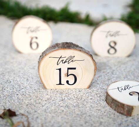 PRICES MAY VARY. Want to have something different and unique for your wedding?! These engraved aspen wood standing slices stand up on each table and have a nice rustic feeling touch to them. Each piece is unique as there will never be two of the same wood slice. Size:Diameter: 4" inches (approximate); Thickness: 3/4-1" inches (approximate). These tree slices are cut on bottom edge and then engraved for a great table decoration. Use them at your cake table, guest book table, or on each table at y Wood Rounds For Centerpieces, Lotr Table Numbers, Wedding Table Numbers Wood, Simple Fall Centerpieces Wedding, Olive Green And Gold Wedding, Wood Wedding Centerpieces, Wood Table Setting, Western Wedding Decor, Wooden Wedding Decor