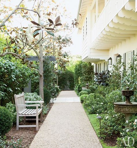 Magnolia trees shade a gravel path lined with boxwood, camellia, and azalea | archdigest.com Hank Azaria, Narrow Garden, Side Yards, Gravel Path, Gravel Garden, Easy Landscaping, Magnolia Trees, Traditional Garden, Garden Pathway