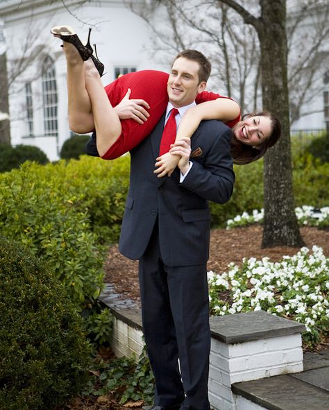 engagement photo of the happy couple - the fiance is carrying his fiancee over his shoulder - photo by North Carolina based wedding photographers Cunningham Photo Artists Holding Someone Over Shoulder Reference, Over The Shoulder Carry Couple, Carrying Someone On Shoulders Pose, Carried Over Shoulder Couple, Thrown Over Shoulder Pose Couple, Boy Carrying Girl Over Shoulder, Carrying Over Shoulder Pose Reference, Shoulder Carry Pose Reference, Carry On Shoulder Pose