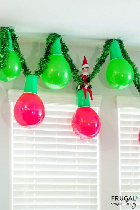 Make an adorable Christmas garland out of balloons and plastic cups in a few simple steps. Enjoy this Elf on the Shelf Balloon Garland and Elf on the Shelf Balloon ideas. This DIY balloon garland idea is quite adorable and adds instant Christmas decor to your cute elf idea. New Elf on the Shelf ideas daily plus free Elf on the Shelf printables. #FrugalCouponLiving #ElfontheShelf Elf Streamer Ideas, Balloons Elf On The Shelf, Elf On The Shelf In Balloon Ideas, Elf On The Shelf Arrival Ideas Hot Air Balloon, Elf On The Shelf Ornaments Diy, Willy Wonka Elf On The Shelf, Elf Inside A Balloon, Elf Ballerina Ideas, Balloon And Solo Cup Christmas Lights