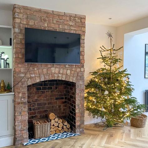 Sarah on Instagram: "Transformation Tuesday Christmas tree number 2 taking pride of place in the kitchen/family room beside the exposed chimney breast I regret not taking more before pictures of this room but if you swipe across, you’ll see a ‘during’ picture when we’d started to pull the plaster back, exposing this beautiful arch. A lot of graft by ourselves later and we’re super happy with the outcome A little secret I’ll share (& before you ask what colour it is), but this room is still Exposed Brick Fireplace Dining Room, Log Burner No Chimney Breast, Exposed Chimney Living Room, Dining Room With Brick Fireplace, Exposed Brick Chimney Breast, Exposed Chimney In Kitchen, Chimney Breast Decor, Exposed Brick Walls Living Room, Exposed Chimney