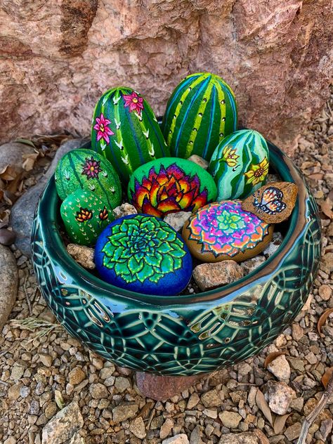 Painted rock art cactus garden Desert Scene Painted Rocks, Painted Rock Garden Landscaping, Rock Cactus Garden Painted Stones, Painted Rocks For The Garden Landscaping, Large Painted Rocks For The Garden, Cactus Rocks Painted, Rock Painting Cactus, Painted Rock Display, Painted Rock Garden Ideas