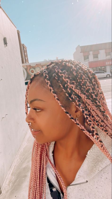 Youthful brown skinned girl with long pink braids looking to the right side Easter Braids For Black Women, Rose Gold Braids, Trending Hairstyles For Black Women, Box Braids Pink, Black Women Protective Styles, Protective Styles For Black Women, Box Braids With Color, Pink Box Braids, Braids Pink