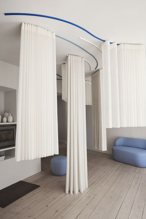 Blue and white ceiling mounted curtain tracks carrying white curtains. Curtain Room Dividers, Room Division, How To Hang Curtains, Curtain Divider, Interior Design Curtains, Curtain Room Divider, Curtain Tracks, Hang Curtains, A Studio Apartment