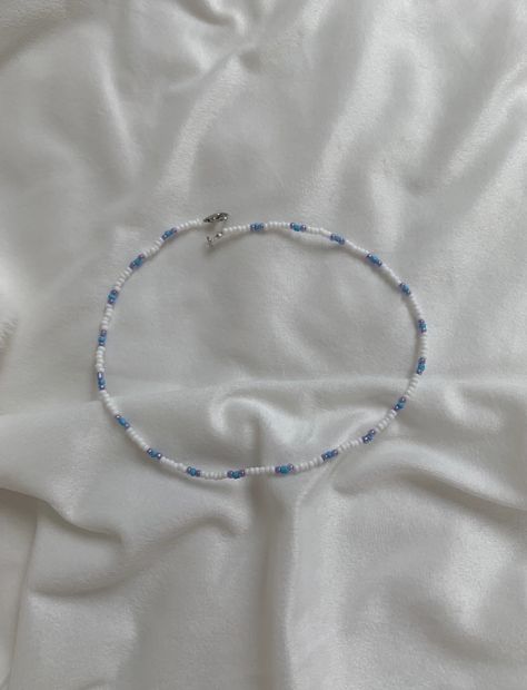 This necklace is made of a white, blue and purple seed beads with a clasp. The beads are small for a cute minimalist look while still having a sophisticated and preppy look. They really fit in with the outer banks style which is so trendy at the moment! It can be styled with so many pieces to make any outfit really cute and trendy. This vsco style is so popular at the moment and this necklace is the perfect fit for that! Something that kiara from outer banks might wear! Gift for him, gift for he How To Make A Cute Necklace, Blue Beaded Necklace Ideas, Small Beaded Jewelry, Minimalist Beaded Necklace, Outer Banks Jewelry Ideas, Minimalist Beaded Jewelry, Small Bead Necklace Ideas, Cute Necklaces To Make, Making Necklaces With Beads