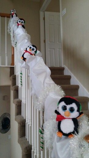 Christmas penguins sledding on stair banister decoration.  Saw a version of this on pinterest and added a few things. Attached long sheet of display snow on the banister, added 5" white wire ribbon in "waves" to create the look of hills/ moguls, threw in some sparkly garland and a couple of candy cane ornaments, and of course the super cute beanie boo penguins (held on with white pipe  cleaner) Christmas Bannister, Christmas Decorations Kids, Banister Ideas, Beanie Boo Party, Beanie Boo Birthdays, Christmas Banister, Christmas Penguins, Stair Banister, Christmas Staircase