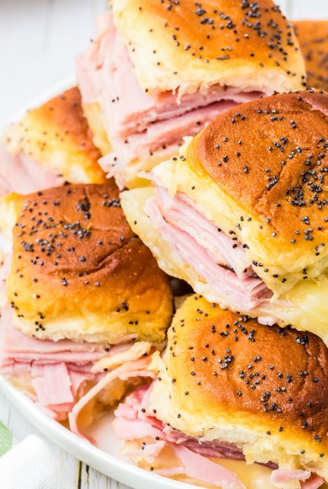 Make these Ham & Cheese Hawaiian Roll Sliders to feed your hungry crowd for dinner, parties, game-day and holidays. Perfectly baked soft rolls filled with ham and cheese then slathered with a honey dijon poppyseed topping. Ham N Cheese Sliders Hawaiian Rolls, Hawaiian Bread Sliders, Hawian Roll Sandwiches, Sliders On Hawaiian Rolls, Hawaiian Roll Sandwiches, Ham Roll Ups, Roll Sliders, Soft Rolls, Stomach Rumbling