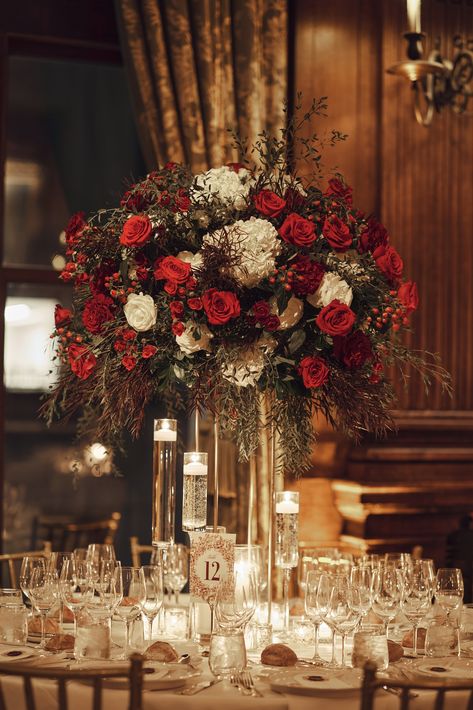 Traditional wintertime floral arrangement with red roses and white hydrangea.  Full, lush flower centerpiece on gold stand surrounded by candles.   Planning | @aniwolff_ Photography @andrewkellyphoto & @fjello for @christianothstudio Reception venue | University Club Photography | @christianothstudio Videography | @mckenziemfilms Florals | @fleursnyc Candles Round Table, Red And Gold Wedding Reception, Red Centrepiece, Candle Tablescapes, Club Photography, Gold Wedding Reception, Red Centerpieces, Global Wedding, Red Hydrangea