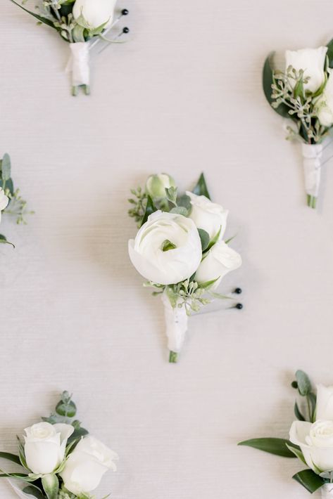 A grooms boutonniere stands out with small white ranunculus. White Bootinterieur, Peony Boutonniere Wedding, Grooms Men Boutonnieres, Mens White Boutineers, Small Ranunculus Bouquet, Buttonholes Wedding White, White Peony Boutonniere, Wedding Bootinterieur, White Bouteniere