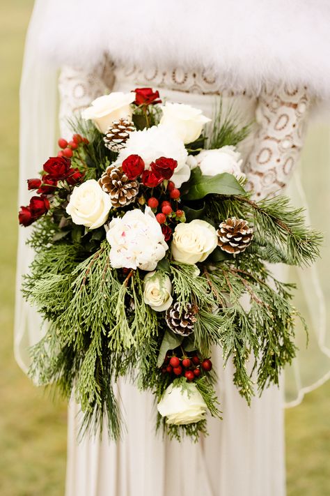 December bride, Winter wedding bouquet, Christmas wedding, white peonies, white roses, burgundy miniature roses, pine ones, Christmas greens, red berries Christmas Cascade Bouquet, Christmas Themed Wedding Bouquet, Red And Green Bridal Bouquet, Winter Wedding Bouquet With Pinecones, Christmas Bridal Bouquet Winter Bride, Bride Bouquets Winter, Red And White Christmas Wedding, Christmas Floral Bouquets, Wedding Bouquets Christmas