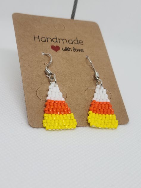 Halloween Candy Corn Beaded Earrings   ITEM DESCRIPTION: - You will receive one pair of sturdy, handcrafted colourful beaded earrings. - These earrings are made using 11/0 glass Miyuki Delica beads, traditional Indigenous beading techniques, and conditioned Nymo beading thread. - The design of these earrings is candy corn. The earrings are done in two drop brick stitch.  - These earrings are very lightweight, and perfect for everyday or formal wear. - As this item is made to order just for you, Beaded Candy Corn, Candy Corn Seed Bead Earrings, Halloween Beaded Earrings Patterns Free, Candy Corn Beaded Earrings, Seed Bead Halloween Earrings, Seed Bead Earrings Patterns Tutorials, Beaded Halloween Jewelry, Halloween Seed Bead Earrings, Fall Beaded Earrings