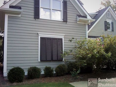 GARAGE MAKEOVER - Remodeling? Don’t leave a large blank wall.  Use wooden Bahamas shutters to create a Faux Window for great Curb Appeal! These Bahamas & traditional Louvered shutters from Sunbelt Shutters have our larger 1-7/8" x 3/8” louvers. . . . #SunbeltShutters #GarageMakeover #BahamaShutters #Shutters #LouveredShutters #ExteriorShutters #CurbAppeal #TraditionalHome #SouthernLivingMag #SouthernLivingHome #slhomes #FunctionalShutters  #RealEstate #SouthernCharm  #betterhomesandgardens #hgtv Exterior Window Ideas, Remodeled Garage, Bahamas Shutters, Wood Window Shutters, Facade Makeover, Front Yard Privacy, Bahamas Style, Bedroom Shutters, Repurposed Shutters