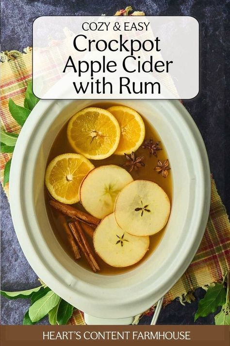 Warm up your autumn nights with this slow cooker spiked apple cider. A blend of apple cider, oranges, spices, and rum creates a deliciously cozy drink that's perfect for fall. Top with whipped cream and caramel for an extra treat! #FallRecipes Cider Crockpot, Apple Cider Easy, Spiked Apple Cider Recipe, Crockpot Apple Cider, Crockpot Drinks, Warm Drinks Recipes, Slow Cooker Apple Cider, Hot Spiced Cider, Spiked Apple Cider