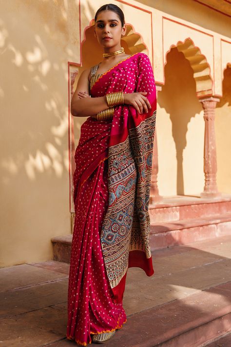 Featuring a magenta pink bandhani saree in gajji silk base with ajrakh hand block print. It is paired with a beige silk printed unstitched blouse. Accentuate it with statement earrings and heels for any festive occasion or wedding ceremony. #Perniaspopupshop #womenswear #ethnic #whatiworewastrending #ppuslove #sareeset #prewedding #bandhani #bandhanisaree #gajjisilk #silk #wedding #weddingwear #bride #festivewear #engagement #sangeet #embroideredlehenga #reception Bandhani Border, Gajji Silk Saree, Beige Blouse, Bandhani Saree, Magenta Pink, Indian Fashion Designers, Hand Block Print, Saree Look, Wedding Wear