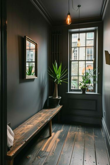 Explore elegant gray hallway ideas that transform your home's passageways into stylish and serene spaces. Hallway Dark Paint, Black Wall Hallway, Dark Paint Hallway, Dark Painted Hallway, Hallway Ideas Dark, Black Walls Hallway, Black Hallway Ideas, Dark Hallway Paint Colors, Gray Hallway Ideas