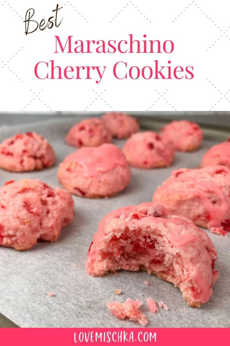 Pink cherry cookies on parchment paper. The closest one has a bite taken out of it to reveal bright red pieces of maraschino cherry and a moist, soft center. Cheery Cherry Cookies, Cherry Wedding Cookies, Cherry Maraschino Cookies, Maraschino Cherry Shortbread Christmas Cookies!, What To Do With Maraschino Cherry Juice, Recipes Using Cherry Juice, Cherry Cake Cookies, Cherry Bell Cookies, Italian Cherry Cookies Recipes