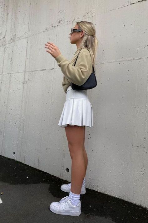 6 Cute White Tennis Skirt Outfit Ideas White Tennis Skirt Outfit Ideas, White Tennis Skirt Outfit Street Style, Tennis Skirt And Sweatshirt, Tennis Skirt Outfit Ideas, Style A Tennis Skirt, How To Style A Tennis Skirt, Tennis Skirt Outfit Summer, Tennis Skirt Outfit Street Style, Outfits November