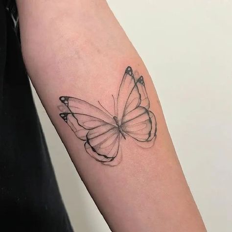 Simple Small Flapping Wings Butterfly Insect Fine Line Tattoo Idea & Design on Woman Bicep Simple Flapping Wings Butterfly Tattoo Done At