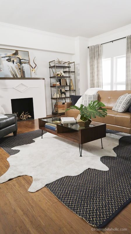 A Living Room Space with a faux cowhide rug, art nouveau fireplace, and touches of gold | Lazyboy Design Dash by Cassity at Remodelaholic Layered Cowhide Rug, Layered Rugs Living Room, Art Nouveau Fireplace, Cowhide Rug Living Room, Faux Cowhide Rug, Rug Over Carpet, Kilim Rug Living Room, Rug Placement, Faux Cowhide