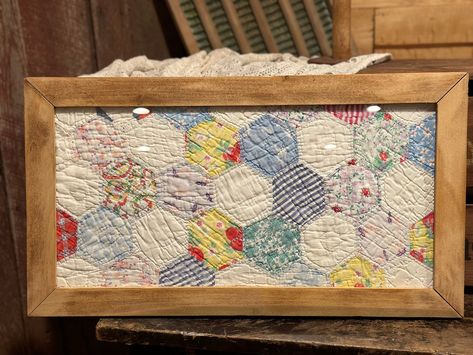 This sweet vintage quilt is framed in a repurposed wood frame. the original quilt was too damaged to repair, so I framed it so this treasure can still be enjoyed. The quilt is made with colorful and delicate fabric. This piece comes ready to hang, with hardware on back. Glass in place in front of quilt. This piece would make a beautiful gift or addition to any home! Quilt Wall Decor, Vintage Quilt Coasters, Framed Quilts Wall Hangings, How To Hang Quilts On Wall, How To Display Quilts In Your Home, Quilt Repurpose Ideas, Old Fabric Diy Reuse, Vintage Quilt Crafts, What To Do With Old Quilts