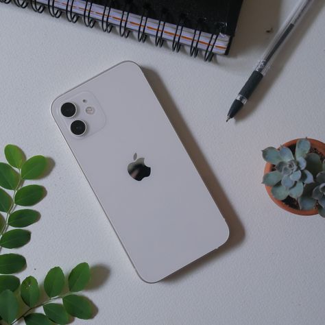 iPhone 12 white on table with plants Iphone 12 Mini White Aesthetic, Iphone 12 Aesthetic White, White Iphone 11 Aesthetic, Iphone 11 Aesthetic Phone, White Iphone Aesthetic, Iphone 12 Pro White, Manifesting Iphone, Iphone 12 Aesthetic, Iphone 12 White