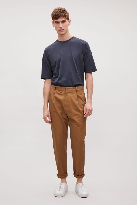 An oversized style, made from a soft cotton, these chino style trousers are a relaxed fit with casual turn-ups. Designed to sit on the hip, they have pleats at the front, classic belt loops and slanted side pockets. Vintage Outfits For Men, Men Chinos, Chinos Men, Vintage Outfits Men, Tan Trousers, Mens Chino Pants, Trousers Men, Tan Guys, Mens Chinos