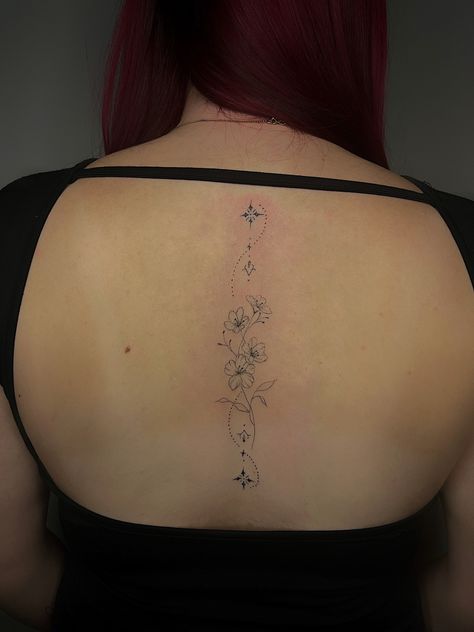 Fine line back tattoo flower tattoo Cherry Blossom Spine Tattoos For Women, Fine Line Girly Tattoos, Floral Fine Line Spine Tattoo, Lilly Spine Tattoo, Dainty Flower Spine Tattoo, Fine Line Spine Tattoos, Fine Line Tattoo Spine, Back Tattoo Fine Line, Daisy Spine Tattoo