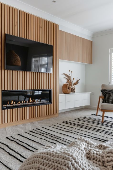 Revamp your living space with stylish fireplace wall designs featuring a wall-mounted TV. Check out more ideas in this article. Wood Panelling Walls Fireplace, Tv Wall Design With Fireplace Modern, Slat Fireplace Wall, Wood Shiplap Fireplace, Panel Fireplace Wall, Shiplap Wall Fireplace, Tv And Electric Fireplace Wall Ideas, Slat Wall Fireplace, Wood Slat Fireplace Wall