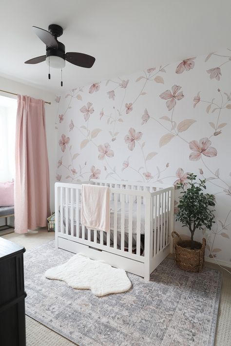 This Baby girl nursery is an absolute dream. Its soft, airy with a touch of punctuation through the black dressert and the floral wallpaper is a stunning foca point! #nursery #nurserydecor #nurseryideas #babygirlnursery #girlbedroomideas #nurseryinspiration #babynurserydecor #lilyjunehome Nursery Baby Girl Wallpaper, Floral Nursery Inspiration, Nursery With Floral Wallpaper, Wallpaper For Nursery Girl, Baby Girl Wallpaper Nursery, Baby Girl Nursery With Wallpaper, Girls Nursery Wallpaper, Black Floral Nursery, Girl Nursery Mural