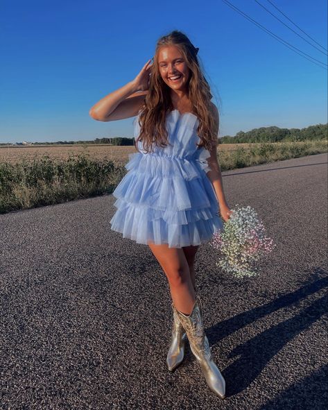 Girl with blue tulle dress and gold cowboy boots Tulle Dress With Cowgirl Boots, Tulle Dress With Cowboy Boots, Homecoming Dresses With Boots, Tulle Dress With Boots, Hoco Dress With Cowgirl Boots, Short Tulle Dress Photoshoot, Puffy Dress With Cowboy Boots, Hoco Dress With Boots, Spring Mini Dress With Tulle Skirt For Prom