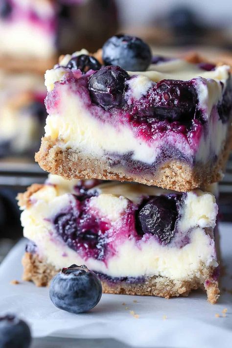 A close-up of a blueberry cream cheese bar with a bite taken out, revealing the rich cheesecake texture and juicy blueberry filling, topped with whole blueberries. Blueberry Cream Cheese Bars, Cream Cheese Bars Recipe, Blueberry Cheesecake Bars, Cheese Bars, Blueberry Filling, Blueberry Bars, Rich Cheesecake, Cream Cheese Bars, Cheese Bar