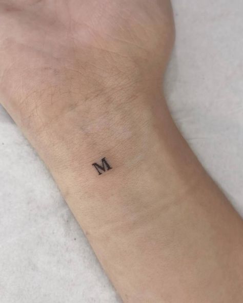 Tiny tattoo of the letter "M" located on the wrist. Mm Initial Tattoo, Tiny M Tattoo, Small M Tattoo Letter, M M Tattoo, Initial Tattoo Men, Initial M Tattoo, M And M Tattoo, M&m Tattoo, Small M Tattoo