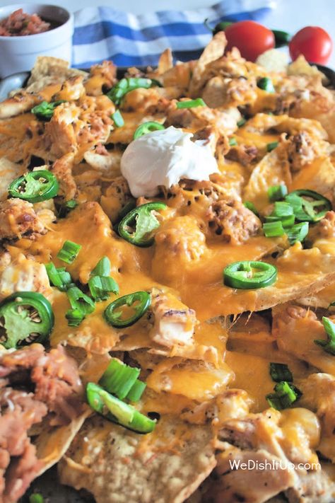 Sheet Pan Chicken Nachos are great for an appetizer, lunch or even dinner. Chicken, beans, cheese, and jalapenos all on tortilla chips. Making these nachos all on a sheet pan makes them easy to throw together when you are in a hurry. Sheet Pan Nachos With Refried Beans, Sheet Pan Nachos Chicken, Chicken Nachos Sheet Pan, Nachos Sheet Pan, Shredded Chicken Nachos, Green Chili Salsa, Sheet Pan Nachos, Pan Nachos, Chicken Beans