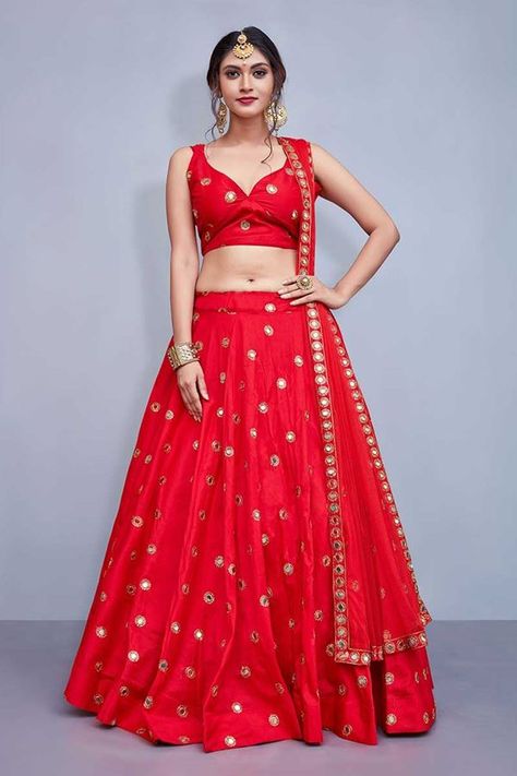 Be the stunner as you don this dazzling red designer lehenga choli set featuring mirror worked motifs spread along the choli as well as floor length lehenga with sequin accentuation, looking brilliant in its overall show! This lehenga choli set is accompanied with matching net dupatta. Simple Lehenga Designs Unique, Simple Lehenga Designs, Red Wedding Lehenga, Red Lehenga Choli, Simple Lehenga, Lehnga Dress, Be Design, Lehenga Blouse Designs, Salwar Designs