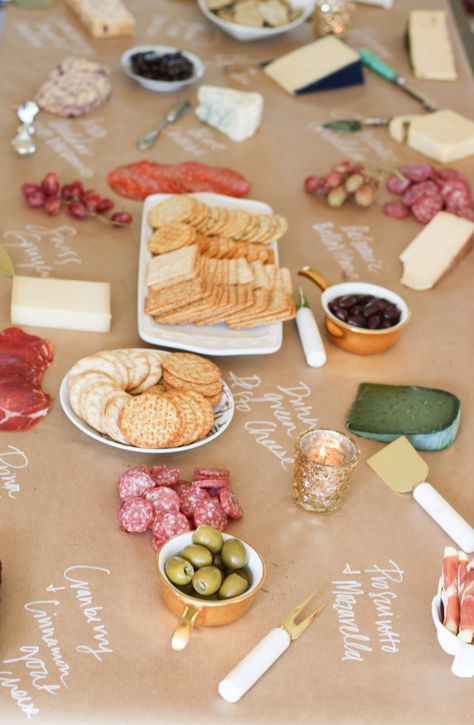 cheese board on kraft paper Kraft Paper Food Table, Butcher Paper Party Decor, Craft Paper Buffet Table, Charcuterie Board Ideas On Brown Paper, Wine And Cheese Party Decor, Charcuterie Board Ideas Butcher Paper, Craft Paper Charcuterie Table, Butcher Paper Tablecloth Party, Kraft Paper Table Setting