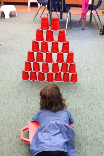 Can stack cups and then do scooter bowling! Stacking Cups, Sensory Motor, Pediatric Physical Therapy, Occupational Therapy Activities, Motor Planning, Pediatric Occupational Therapy, Gross Motor Activities, Pediatric Therapy, Sensory Integration