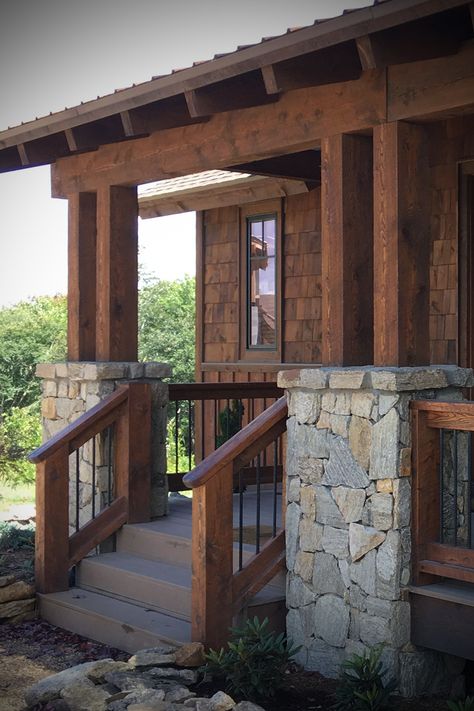 Rustic veneer stone home cabin Highland Scotch Webwall stone veneer w/ fieldstone natural stone pieces for outdoor stone fireplace as well as exterior stone veneer w/ wood beams, shakes, pillars & dark window trim. Exterior stone cladding & indoor/outdoor fireplace perfect for mountain stone home. DIY masonry blog https://www.buechelstone.com/masonry/ & how to install stone (mortar / dry stacked stone) for exterior & interior wall stone design. #ExteriorStone #OutdoorFireplace #StoneVeneer Stone And Cedar Columns, Stone Wanescoat Exterior, Stone And Wood Pillars, Stone And Wood Cabin, Stone With Brick Exterior, Wooden Exterior House, Stone Paneling Wall, Rustic Home Exterior Design, Stone Wainscoting Exterior