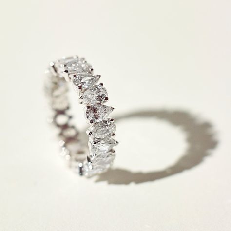 A breathtaking reinterpretation of the eternity band, diamond-shaped pears are hand placed at precise angles to symbolize perfect complementarity. Recycled 18k gold hold in place D color, IF/VVS clarity pear-shaped diamonds. Size and color are fully customizable. Available in two carat weights: 2.5 and 5 (based on a U.S. size 7). Total carat weight varies based on ring size. Pear Eternity Ring, Unique Eternity Ring, Diamond Ring Bands, Pear Wedding Band, Ring Enhancers, Eternity Diamond Ring, Trilogy Engagement Ring, Pear Ring, Diamond Eternity Ring