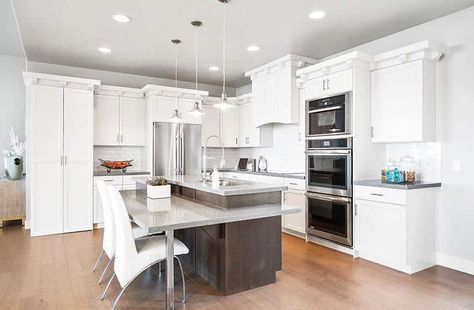 Modern kitchen with two tier island with seating gray quartz countertops Two Tiered Kitchen Island, Tiered Kitchen Island, Floating Kitchen Island, Kitchen Cabinet Trends, Gray Quartz, White Shaker Kitchen, Above Kitchen Cabinets, Shaker Kitchen Cabinets, Modern Kitchen Island