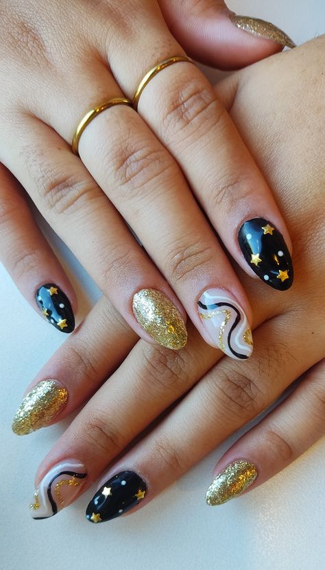 #2022 #2023 #nails #nailart #newyear #newyearnails #gold #black #white #star #holiday #holidaynails Gold Firework Nails, Newyears Nails 2021, January Nail Art Ideas, Gold White And Black Nails, Black And Gold Abstract Nails, Black And Gold Star Nails, Starcatcher Nails, Graduation Nails Black And Gold, Black Gold White Nails