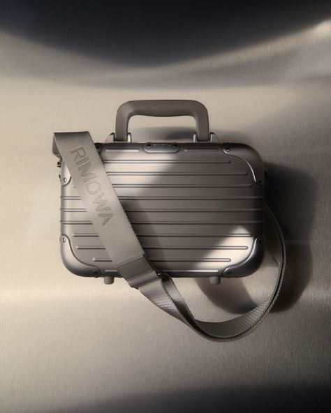 @Rimowa's core values of style and functionality have shaped their designs for over a century. Known for blending craftsmanship and engineering, the German brand creates robust yet elegant luggage. Now, Rimowa applies these principles to the Original Bag, a compact new piece featuring the signature grooves of their iconic aluminium suitcases. Made in Germany, the lightweight, unisex design can be carried by hand, over the shoulder, or cross-body, showcasing Rimowa's sleek, durable aesthetic.⁠... Rimowa Luggage Aesthetic, Rimowa Luggage, City Car, Original Bags, Colour Board, Core Values, Black Aesthetic, Unisex Design, Iphone 16