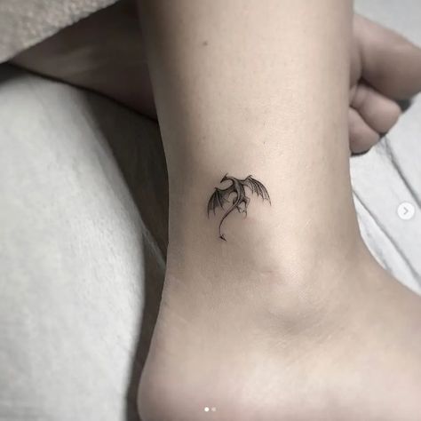 Minimalist Tiny Dragon Tattoo | TattooDesign Dragon Ankle Tattoo, Tattoo Lower Back, Targaryen Tattoo, Tattoo Ankle, Dragons Tattoo, Small Dragon Tattoos, Small Dragon, Tattoo Placements, Dragon Tattoo For Women